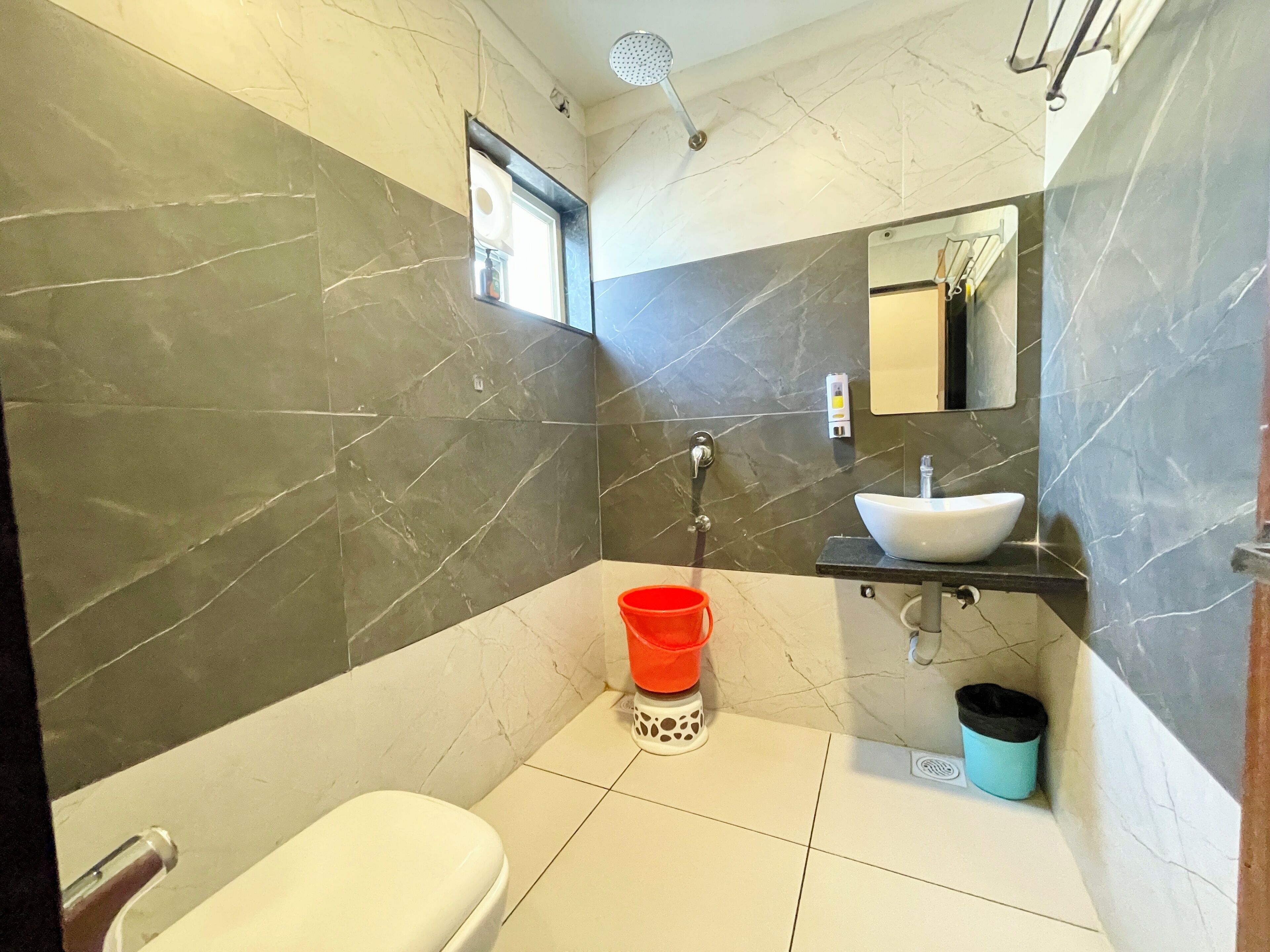 A modern bathroom with a toilet, sink, and shower.