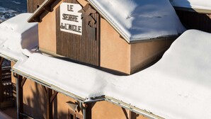A snow-covered building with a sign that reads "LE SHERRRE de L'ANGLIERE".