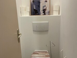 A door with a light switch, a towel dispenser, and a small wooden object on the floor. - 3-room apartment, 6 people - Pets allowed, near slopes (Orcières Merlette)