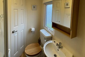 Huisje | Badkamer | Een douche, een haardroger, handdoeken, toiletpapier