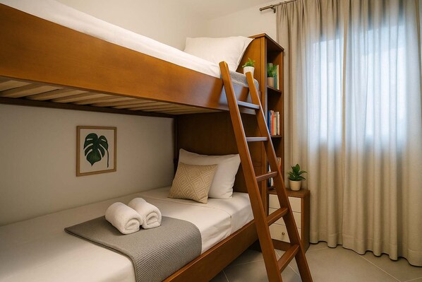 A bunk bed with a ladder, a bedside table with a plant, and a framed picture on the wall. - Onar Zin Seabliss - Iro Pool Bliss Getaway (Xylokastro-Evrostina)