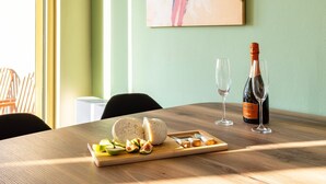 A wooden table with a cheese platter, two glasses, and a bottle of wine. - Martinia Pool Escape - Tragos Panoramic Views (Kalamata)