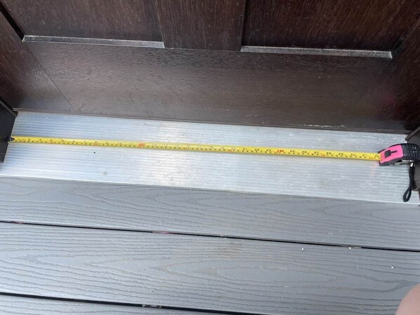 A wooden staircase with a measuring tape.