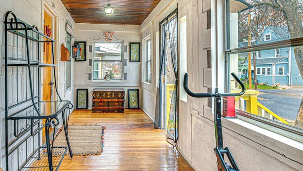 A corridor with wooden floors, a bench, and a bicycle rack. - 1 Mi to Dtwn: Colorful Binghamton Home (Binghamton)