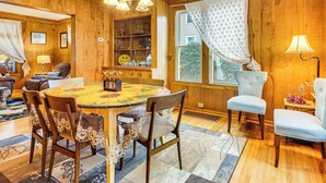 A wooden-paneled room with a round dining table, chairs, and a chandelier. - 1 Mi to Dtwn: Colorful Binghamton Home (Binghamton)