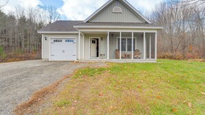 A single-story house with a garage, a covered porch, and a front yard. - Ski, Hike & Boat: Modern Bridgton Retreat (Bridgton)