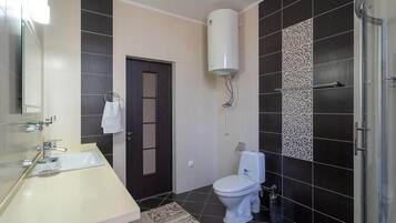 Shower, hair dryer, slippers, towels