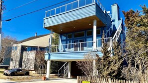 A two-story building with a blue exterior, a balcony, and a wooden fence. - OCEANBLOCK PROPERTY WITH AMAZING DECKS! (Rehoboth Beach)