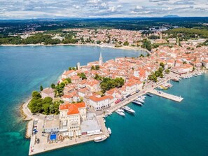 An aerial view of a coastal town with a marina, historic buildings, and a prominent church tower. - Welcoming Apartment With Garden (Porec)