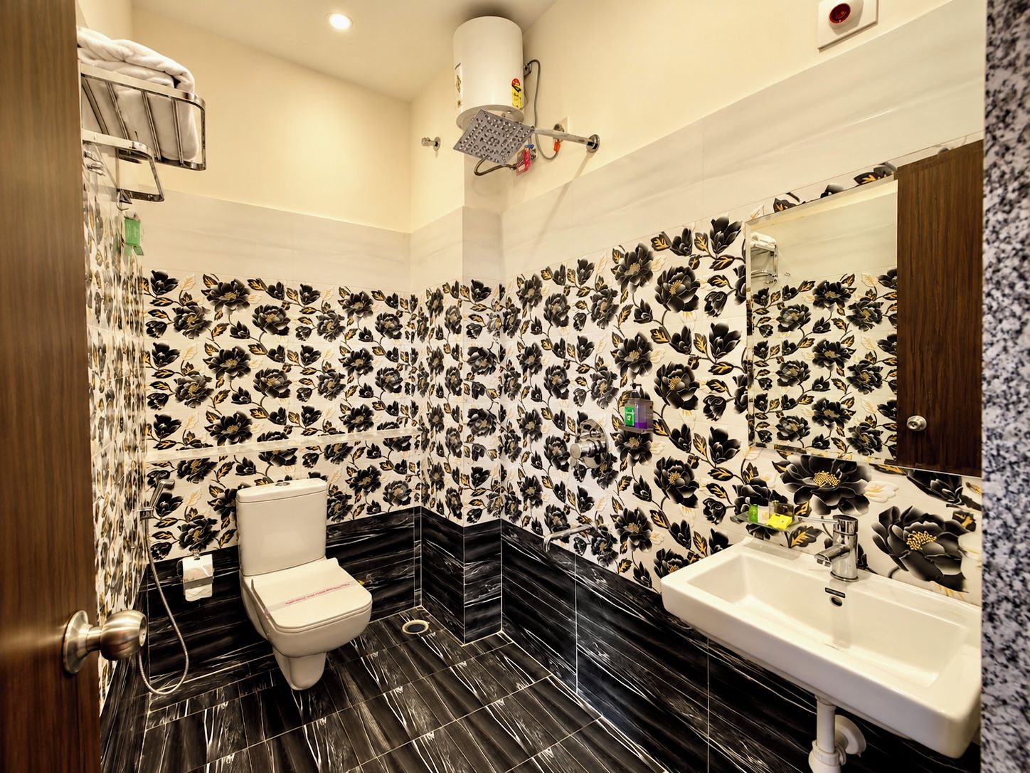 A bathroom with a toilet, sink, and shower.