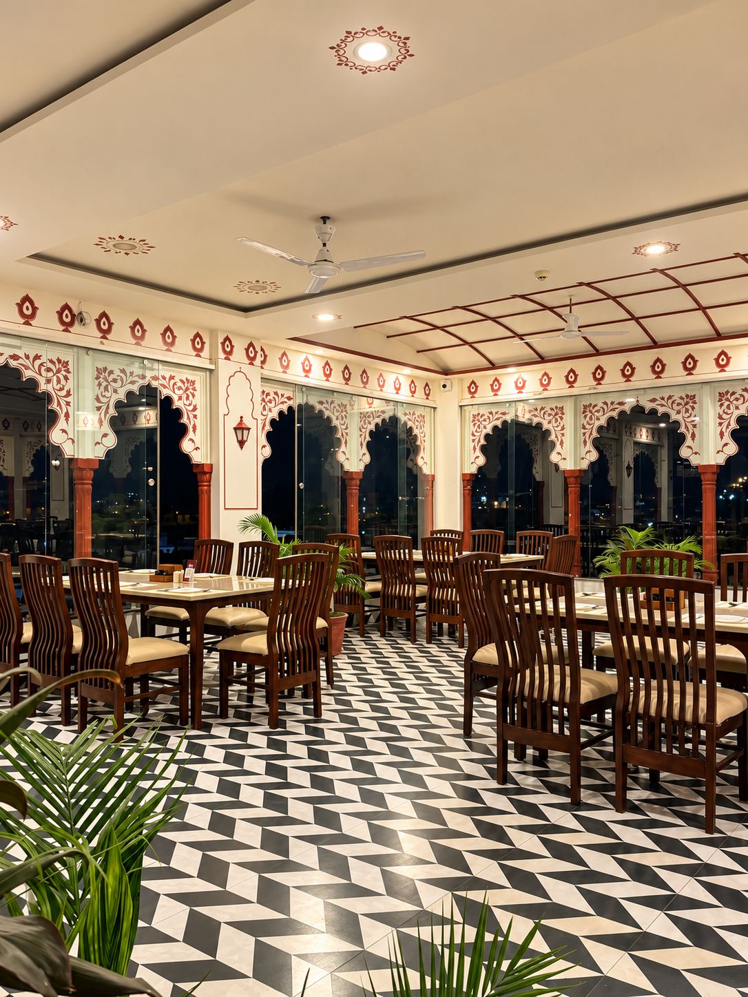 A restaurant with a checkered floor, wooden chairs, and tables.