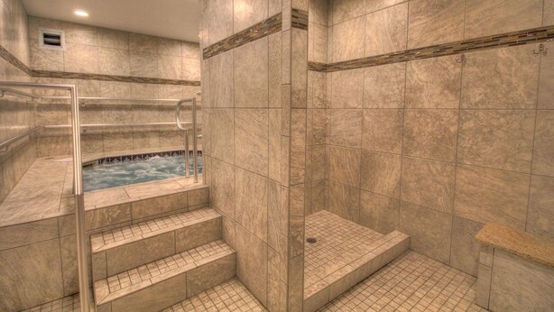 A spa area with a hot tub, tiled walls, and a glass-enclosed shower. - 620 El Matador 1 Bedroom Condo (Fort Walton Beach)