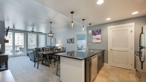 A modern kitchen with a central island, built-in appliances, and pendant lighting. - Premium Unit 4285 Fraser Crossing/founders Pointe 2 Bedroom Condo (Winter Park)