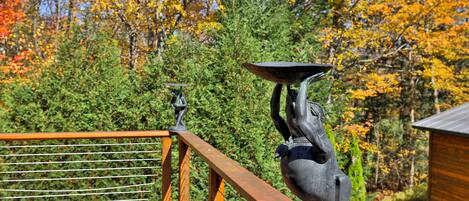 Una terraza de madera con una escultura de metal que representa a un jinete y su caballo.