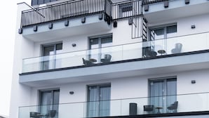 A modern multi-story building with balconies, large windows, and outdoor seating areas. - BRIGHT Schloß Holte-Stukenbrock (Schloss Holte-Stukenbrock)