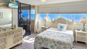 A bedroom with a bed, a dresser, a TV, and a view of the ocean. - 20th Floor Ocean Front Condo! Steps to the Beach and Ocean! Atlantis #2004 (Ocean City)