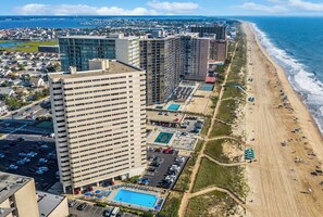 A high-rise hotel with multiple floors, a swimming pool, and a beach view. - 20th Floor Ocean Front Condo! Steps to the Beach and Ocean! Atlantis #2004 (Ocean City)