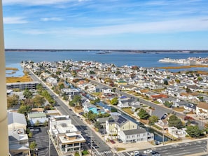 A residential area with houses along a waterfront, a road, and a small body of water. - 20th Floor Ocean Front Condo! Steps to the Beach and Ocean! Atlantis #2004 (Ocean City)