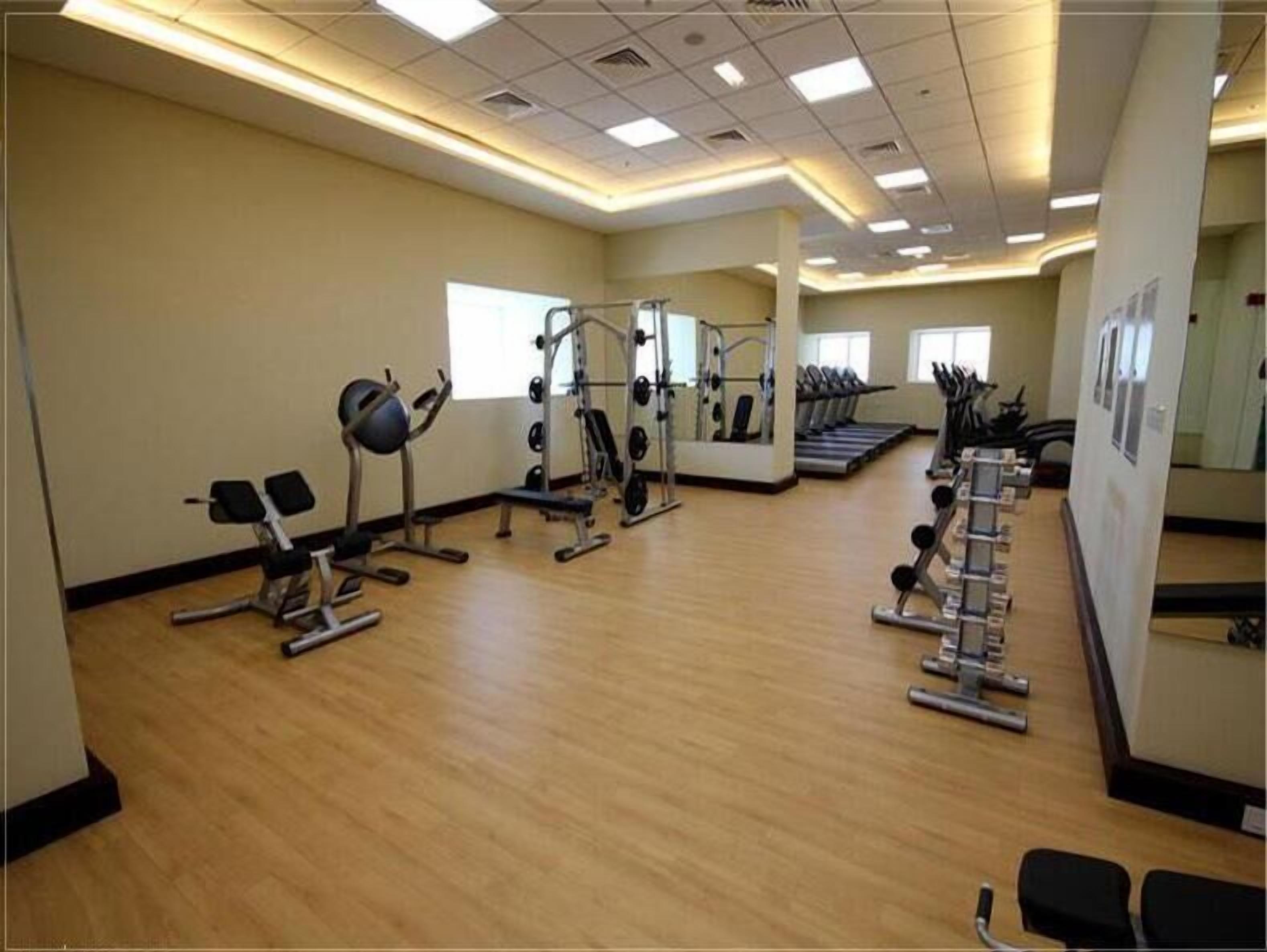 A gym with various exercise equipment, including weight machines and treadmills.