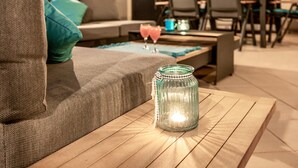 A cozy living area with a sofa, a coffee table with a candle, and a glass jar. - Rooftop Paradise with Sea View - Katja (Medulin)