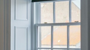 A window with a white frame and a black roller blind. - No 2 @ The Rocket Rooms Apartments  (Berwick-upon-Tweed)