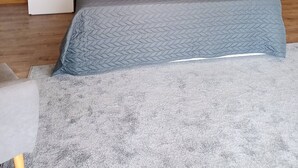 A modern bedroom with a large bed, a wooden nightstand, and a grey headboard. - R3 Service Casa do Pomar (Vouzela)