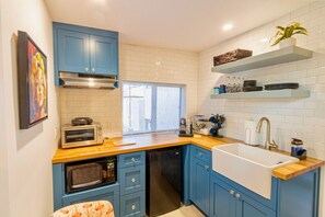 Microwave, stovetop, coffee/tea maker, cookware/dishes/utensils