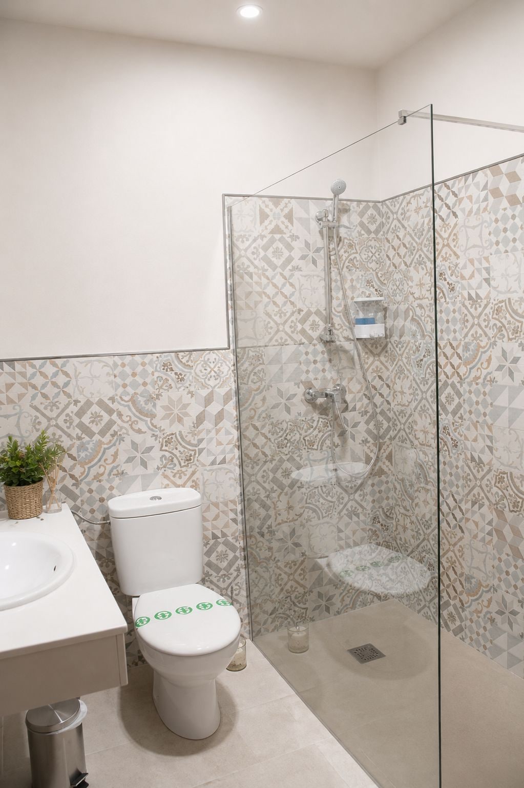 A bathroom with a toilet, sink, and shower area.