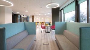 A modern interior with seating areas, a central table, and large windows. - Crow's Nest (Cork)