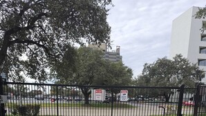 A gated entrance with a 'No Exit' sign and a 'Warning: Security Cameras in Use' sign. - Furnished and Spacious 2-Bedroom Apartment in Downtown Dallas Medical District (Dallas)