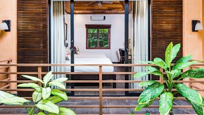 A room with a bed, a window with curtains, a ceiling fan, and a small table. - Beachfront Villa in  Playa Langosta, Tamarindo! (Playa Langosta)