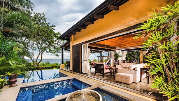 A pool area with a hot tub, outdoor seating, and a view of the sea. - Beachfront Villa in  Playa Langosta, Tamarindo! (Playa Langosta)