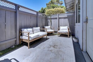 A patio with a wooden bench, a sofa, and a chair. - Designer Condo in Hip Zen Yard! Midtown Phoenix! (Phoenix)