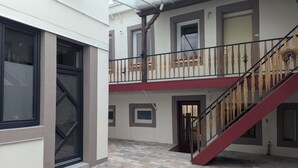 A multi-level building with a staircase and a balcony.