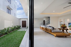 Contemporary interior with a seating area, staircase, and minimalist design.