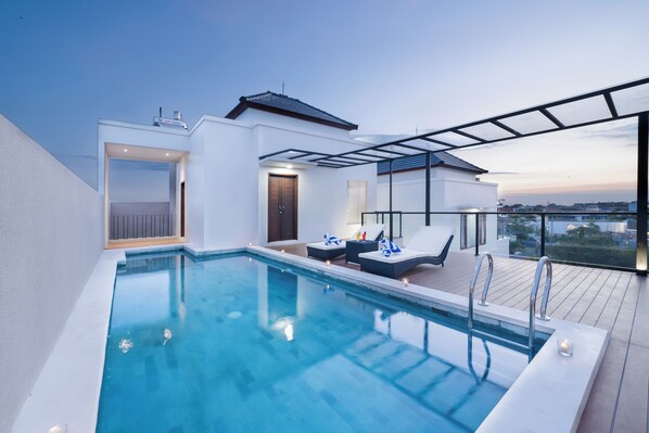 Relax by the pool with a clear view of the city skyline.