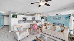 A spacious living room with a sofa, armchairs, a coffee table, and a ceiling fan. - Seaside Beach & Racquet 3305 (Orange Beach)