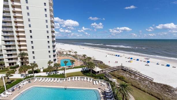 A hotel with a pool, beach, and ocean view. - Seaside Beach & Racquet 4708 (Orange Beach)