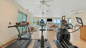 Ein Fitnessstudio mit Laufbändern, Crosstrainern und einem Ergometer.
