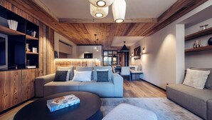 Una sala de estar moderna con techo de madera, un sofá gris, una mesa de centro redonda y estanterías empotradas de madera.