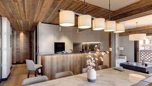 Una cocina moderna con vigas de madera en el techo, una isla de mármol e iluminación colgante.
