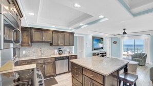 A modern kitchen with granite countertops, stainless steel appliances, and a large island. - Sugar Beach 241 (Orange Beach)