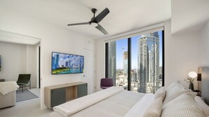 A modern bedroom with a bed, a desk, a chair, and a large window with a city view. - 601 RESIDENCES SKY FLOOR 1BR UNIT #2611 (Miami)