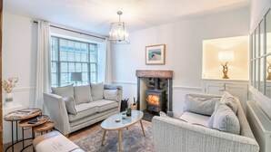 A living room with a fireplace, two sofas, a coffee table, and a lamp. - Warrington House-UK48465 (Thornton-le-Dale, near Pickering)