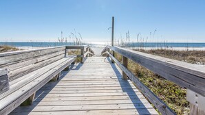 A wooden boardwalk leading to the beach with railings on both sides. - The Breakers 42 (Orange Beach)