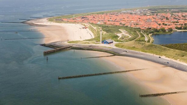 An aerial view of a coastal town with a beach, a lighthouse, and a pier. - Holiday Home Near Beach With Sunny Terrace (Westkapelle)