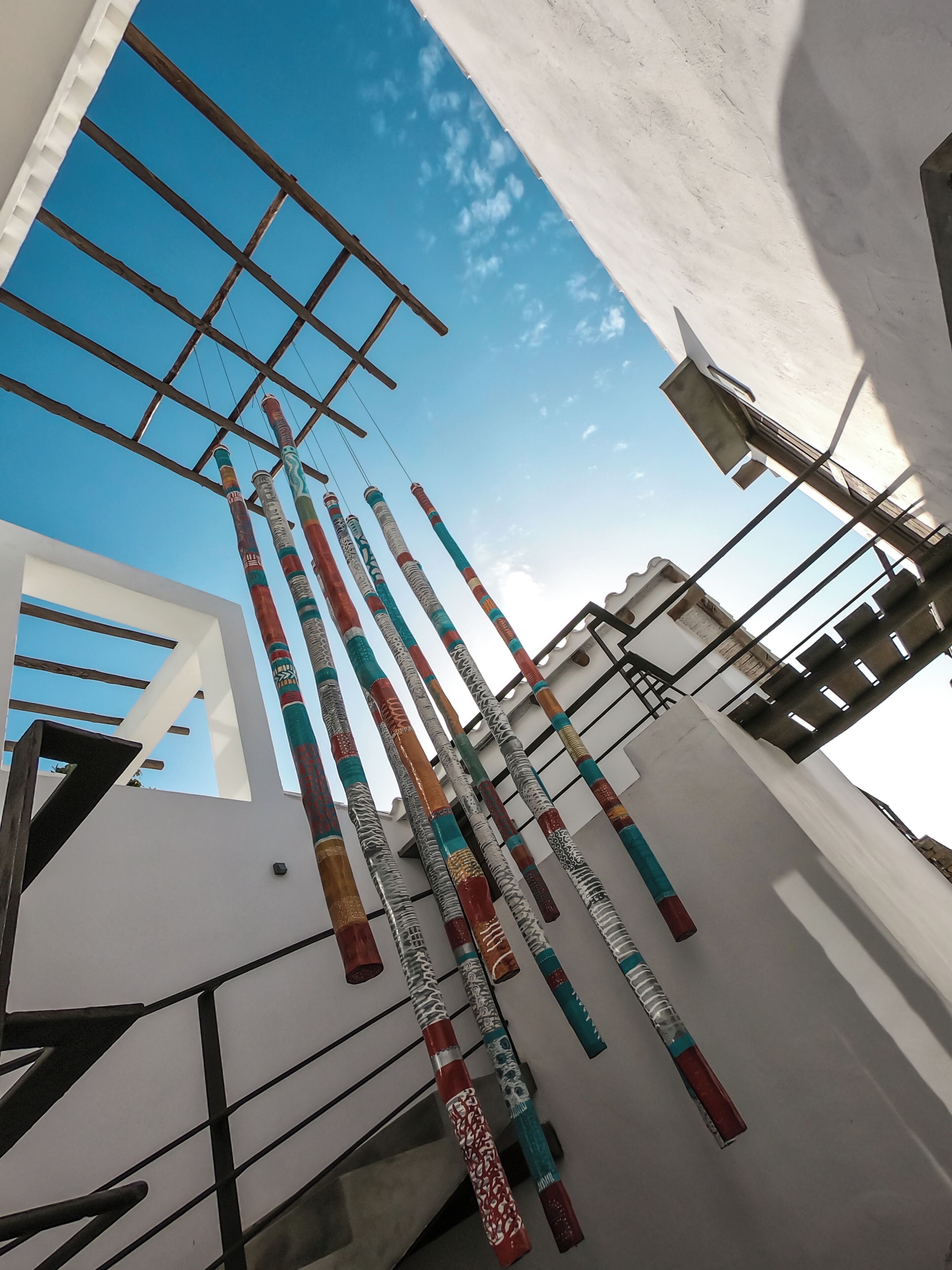 A modern building with a white facade and a metal framework.
