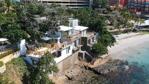 A beachfront property with multiple levels, outdoor seating, and a view of the beach. - Aria Boutique BY LD Hoteles (Maneiro)