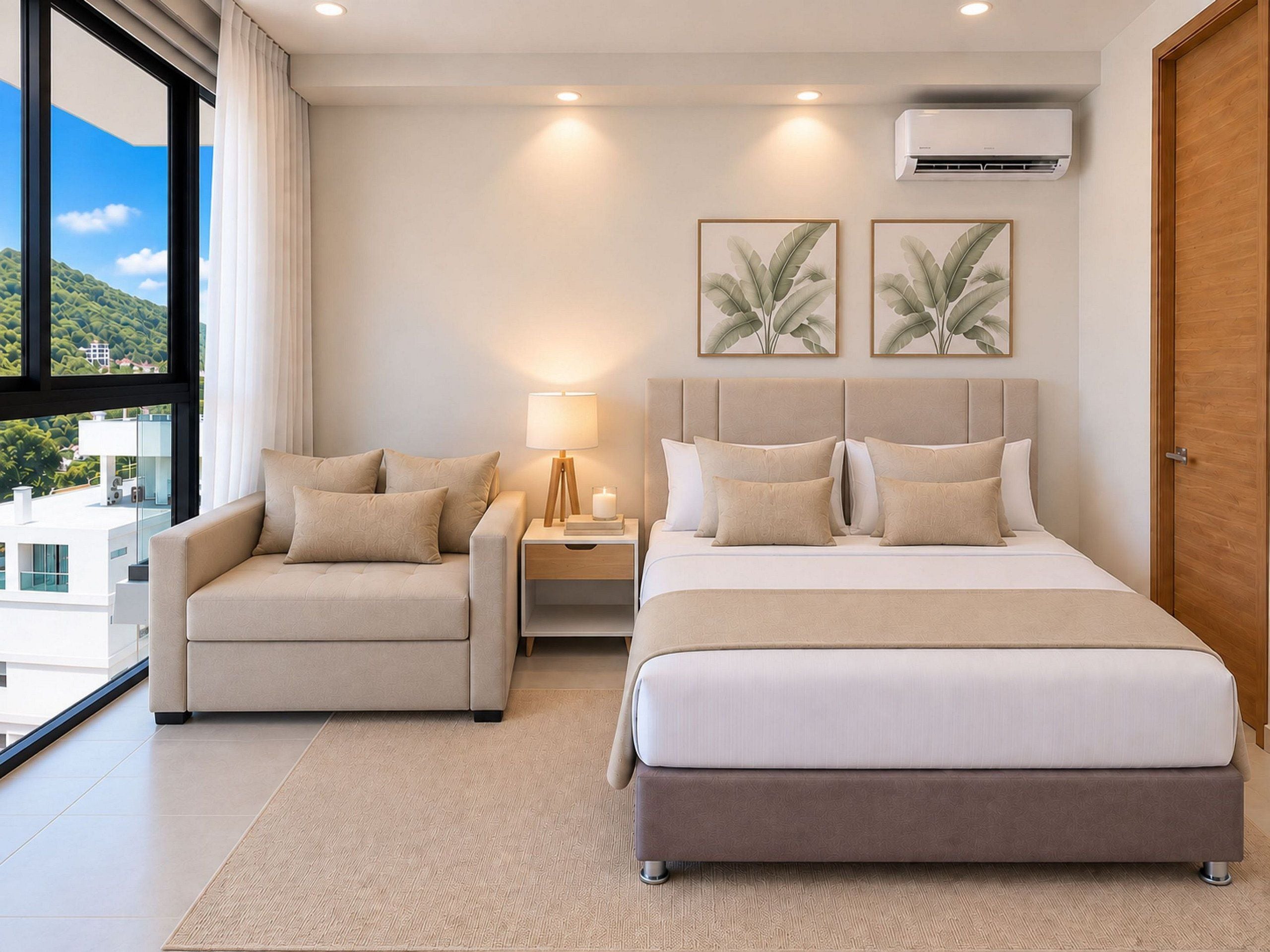 A hotel room with a bed, a chair, a nightstand, a lamp, and two wall-mounted air conditioning units.