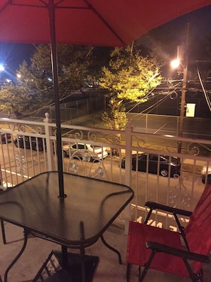 Enjoy a balcony with a table and chair, offering a view of the surrounding street.